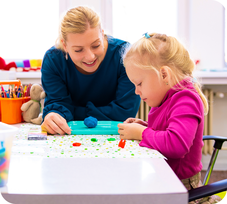 Teacher and child engaged in creative activity.