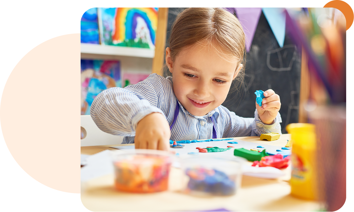 Child creating art with colorful clay.